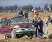  ?? Gina Ferazzi Los Angeles Times ?? CHP investigat­ors work near El Centro after an SUV carrying 25 people collided with a big rig, killing 13.