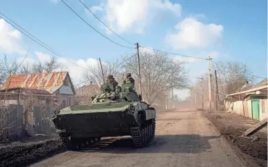  ?? EVGENIY MALOLETKA/AP ?? A Ukrainian armored personnel carrier drives toward front-line positions Saturday near Bakhmut, Ukraine. Russian forces have spent months trying to capture the city as part of their offensive in eastern Ukraine.