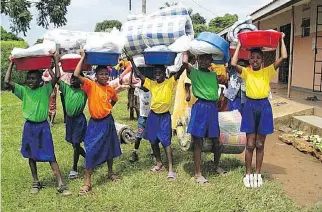  ?? SLEEPING CHILDREN AROUND THE WORLD ?? A group of children with bedkits in Uganda.