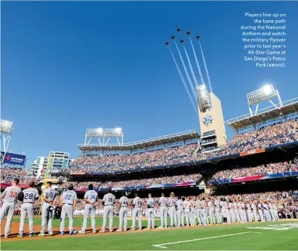  ??  ?? mlayers line up on the base path during the kational Anthem and watch the military flyover prior to last year’s All-star dame at San Diego’s metco mark (ƚƛƨưƞ).