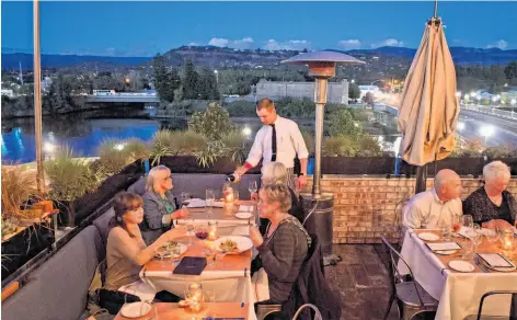  ?? Photos by John Storey / Special to The Chronicle ?? The Thomas’ third floor has a surprising­ly scenic patio that looks over the Napa River and the rolling hills and mountains beyond.