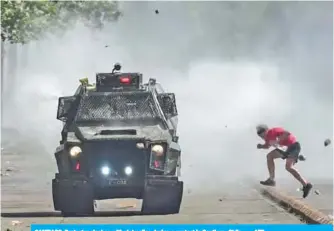  ??  ?? SANTIAGO: Protester clashes with riot police during a protest in Santiago, Chile. — AFP