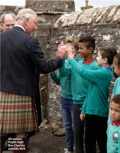  ??  ?? All smiles: Pupils high five Charles outside kirk