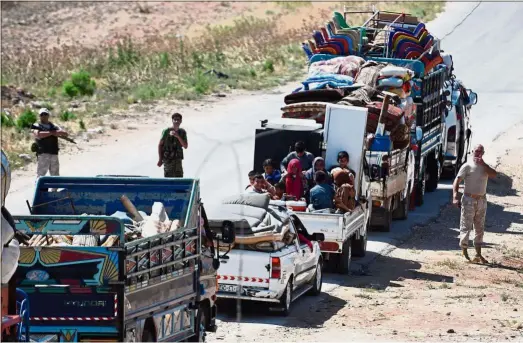  ??  ?? On the move: Russian military police guiding a convoy returning displaced people to government­controlled territory at the Abu al-Zuhur checkpoint in Idlib province. — AFP