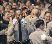  ?? Irfan Khan Los Angeles Times ?? CLASS 464 of the L.A. County sheriff’s academy celebrates Friday during a graduation ceremony.