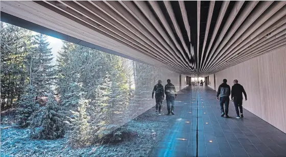  ?? DARRYL DYCK PHOTOS THE CANADIAN PRESS ?? People walk down a long hallway with a view of the outdoors at the Audain Art Museum in Whistler, B.C.