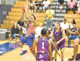  ?? PAUL W. GILLESPIE/CAPITAL GAZETTE ?? Anne Arundel County Fire’s Phil Lyons goes for the basket. The Chase Your Dreams initiative hosted charity basketball games at the Annapolis High School as part of a Social Justice Weekend on Saturday.