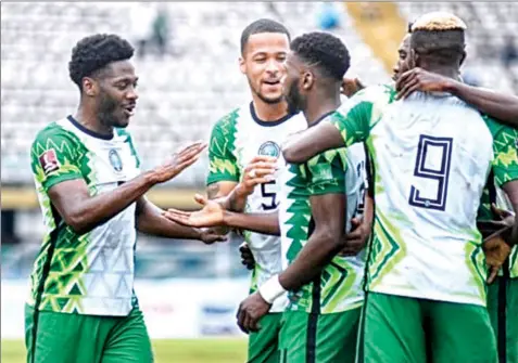  ??  ?? Kelechi Iheanacho being congratula­ted by teammates after scoring the second goal fore the Super Eagles in their 2022 World Cup qualifier against Liberia at the Teslim Balogun Stadiun, Lagos…. yesterday