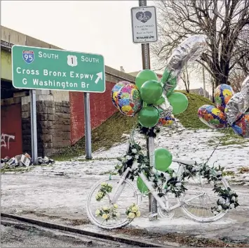  ?? Stephen Speranza / The New York Times ?? A ghost bike memorial is decorated on Webster Avenue just beyond the overpass of the Cross Bronx Expressway where an ambulance was stationed Dec. 23.