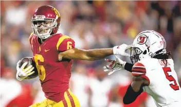  ?? KYUSUNG GONG AP ?? USC wide receiver Michael Pittman Jr. sprints with the ball past Utah defensive back Tareke Lewis last season. Pittman was drafted by the Indianapol­is Colts, which means he’ll be catching passes from Philip Rivers.