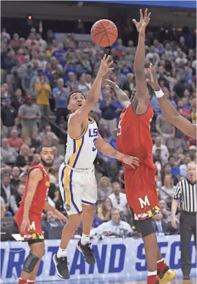  ?? AP ?? LSU guard Tremont Waters (3) makes the game-winning shot as Maryland’s Jalen Smith (25) defends Saturday in Jacksonvil­le, Fla.