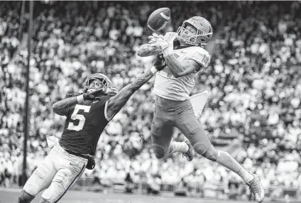  ?? Barry Reeger / Associated Press ?? Penn State’s Tariq Castro-Fields, left, breaks up a pass intended for Illinois’ Casey Washington in the second half. Washington caught the game-winning 2-point conversion pass in the ninth overtime, the first-of-its-kind game in NCAA history.