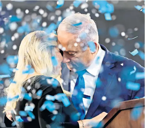  ??  ?? Benjamin Netanyahu rejoices with his wife, Sarah, while celebratio­ns were premature for Benny Gantz, left, and his supporters, top left