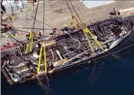  ?? THE ASSOCIATED PRESS ?? This photo shows the burned hull of the scuba dive boat Conception as it’s brought to the surface by a salvage team off Santa Cruz Island in September.