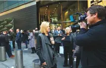  ?? AP ?? CNN correspond­ent Kate Bolduan reports from in front of the Time Warner Building, where NYPD personnel removed an explosive device on Wednesday.