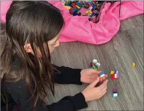  ?? The Canadian Press ?? Rachel Kilgour, 10, of Ottawa plays with LEGO blocks in a handout photo. Her mother Megan Kilgour is planning to homeschool this September.