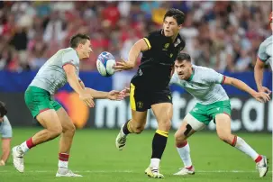  ?? PAVEL GOLOVKIN/THE ASSOCIATED PRESS ?? Wales’ Louis Rees-Zammit, center, passes during the Rugby World Cup Pool C match against Portugal on Sept. 16 in Nice, France. Rees-Zammit is one of 16 athletes from eight countries participat­ing in the NFL Internatio­nal Player Pathway program.