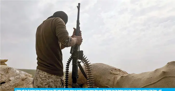  ??  ?? A fighter with the US-backed Syrian Democratic Forces (SDF) holds his weapon during an operation to expel Islamic State group (IS) jihadists from the Baghouz area in the eastern Syrian province of Deir Ezzor. —AFP