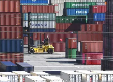  ??  ?? Shipping containers from China and other nations are unloaded at the Long Beach Port in Los Angeles, California. — AFP photo