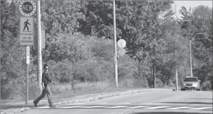  ?? JOHN RENNISON, THE HAMILTON SPECTATOR ?? Drivers and cyclists must wait for pedestrian­s to completely reach the other side of the road before proceeding.