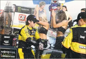  ?? Jeff Siner / TNS ?? NASCAR driver Ryan Blaney sprays champagne on his teammates in Victory Lane at Charlotte Motor Speedway in Concord, N.C. on Sept. 30.