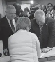  ?? RENÉ JOHNSTON/TORONTO STAR ?? Mayor Rob Ford, right, with brother Doug, registers Thursday at Toronto City Hall to run for re-election in November.