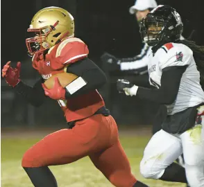  ?? ?? Andrean’s Antonio Barnes heads to the end zone past Bishop Luers’ R.J. Hogue after intercepti­ng a pass Friday night.