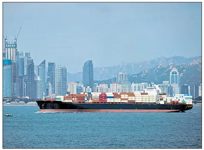  ?? AP/Chinatopix ?? A container ship sails past the business district in Qingdao, China. President Donald Trump’s tweet Thursday regarding trade talks with China ruffled the equities markets.