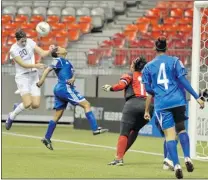  ?? IAN LINDSAY/ PNG ?? Abby Wambach of the United States goes high in the air to head a ball toward the net during Friday’s match against the Dominican Republic. Wambach scored on the play — 37 seconds into the match — and added another goal later as her team won 14- 0 in...