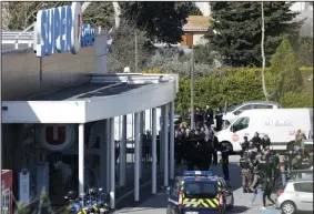  ?? JOSE SANTOS/XINHUA ?? Policemen are seen outside a supermarke­t in Trebes, southern France on Friday. Armed police have killed a suspect who shot dead three people in a series of attacks in southern France.