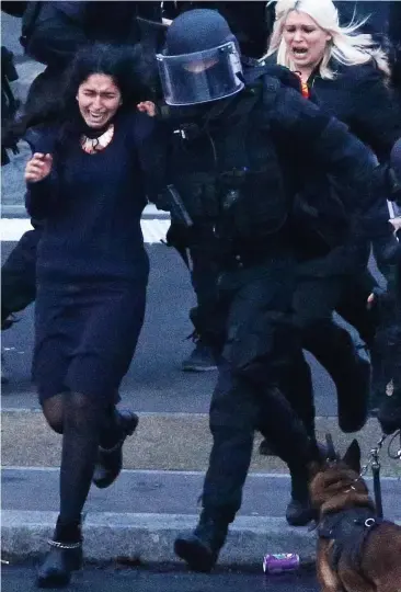  ??  ?? Running to freedom: Hostages are rushed from the Jewish deli by armed police