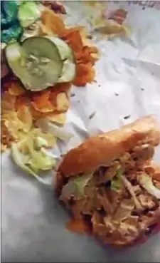  ?? SUBMITTED IMAGE ?? Two maggots are seen crawling on the sandwich wrapper of this Wawa buffalo chicken cheesestea­k hoagie that was purchased on Sept. 23, 2017 at the new Ewing Wawa.