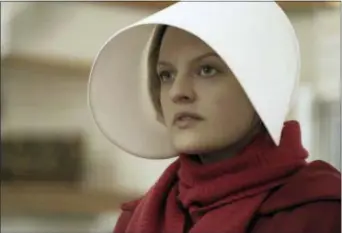  ?? ASSOCIATED PRESS ?? This image released by Hulu shows Elisabeth Moss as Offred in a scene from ‘The Handmaid’s Tale.’