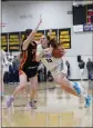  ?? ?? Pleasant Valley guard Maddux Wilson (13) drives to the basket against Chico guard Campbell Vieg (5) on Friday at Butte College.