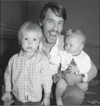  ??  ?? Johnny Moore IV with son John V, 2, and daughter Rosalee, seven months