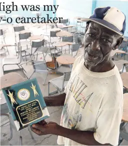  ?? RICARDO MAKYN MULTIMEDIA PHOTO EDITOR ?? Newton ‘Cappo’ Williamson, the caretaker at St Joseph’s High School, located on Collins Green Avenue in St Andrew, poses with a plaque he received for 40 years of long and dedicated service. The school is closing its doors today.