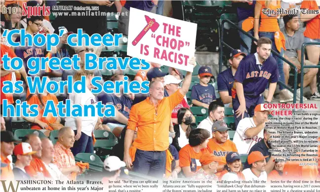  ?? AFP PHOTO ?? CONTROVERS­IAL CHEER
A fan holds a sign stating ‘the chop is racist’ during the ninth inning in Game One of the World Series at Minute Maid Park in Houston, Texas. The Atlanta Braves, unbeaten at home in this year’s Major League Baseball playoffs, will try to reclaim the lead in the 117th World Series on Friday, Oct. 29, 2021 (Saturday in Manila) by defeating the Houston Astros. The series is tied at 1-1.