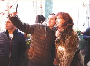  ?? (Reuters) ?? FORMER PRESIDENT Cristina Fernandez de Kirchner, running mate of presidenti­al candidate Alberto Fernandez, takes a selfie with a supporter after casting her vote at a polling station in Rio Gallegos on Sunday.