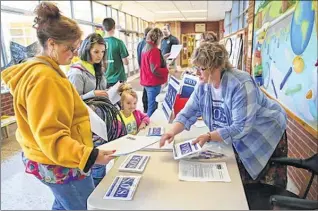  ??  ?? Rainie Pellien of Wauwatosa (left), the grandmothe­r of a student at Underwood Elementary School, and Danielle Schuh, with her 4-year-old daughter Farrah, talk to Darnelle Kaishian about Wauwatosa S.O.S., a group that is advocating for increases in...