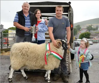  ?? Photos by Declan Malone ?? Benny Clifford from Keel, who had the champion scotch ram at the West Kerry Show on Sunday, with his father Paul, Ellen Houlihan, and her daughter, Caroline.