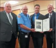  ?? EVAN BRANDT — DIGITAL FIRST MEDIA ?? Retiring Pottstown police Chief Rick Drumheller, second from left, receives a Pennsylvan­ia House of Representa­tives resolution recognizin­g his 30 years of service with the department from, at left, state Rep. Tim Hennessey, and state Reps. David Maloney and Tom Quigley, right.