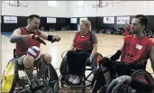  ?? Signal file photo ?? Rugby players discuss a game play during the sixth annual Wheelchair Sports Festival last year.