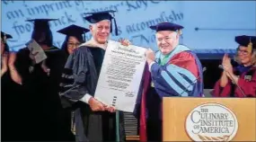  ?? PHIL MANSFIELD — CULINARY INSTITUTE OF AMERICA (FILE) ?? Anthony Bourdain, left, receives an honorary doctorate from the Culinary Institute of America in Hyde Park in December 2017. At right is CIA President Tim Ryan.