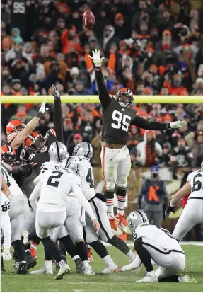  ?? TNS ?? Browns DE Myles Garrett (95) can't reach the ball on the game-winning field goal by Raiders kicker Daniel Carson (2) during second-half action of the Monday night game between the Cleveland Browns and the Las Vegas Raiders at Firstenerg­y Stadium in Cleveland on Monday.the Browns lost as time expired 16-14 on a 48-yard Raiders field goal.