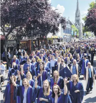  ?? PHOTOS: GERARD O’BRIEN ?? Lively parade . . . Otago Polytechni­c students walk along George St yesterday morning, before two afternoon graduation ceremonies.