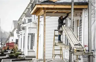  ?? JIM NOELKER / STAFF ?? Nestor Uzhca hangs siding on a newly constructe­d house in Miamisburg earlier this month. Total new permits pulled for 2023 numbered 1,697, down 14.8% from 2022, according to Home Builders Associatio­n of Dayton. A proposed bill would combat a deepening housing shortage in Ohio.