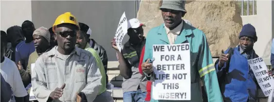  ??  ?? Former workers of Lily Mine picket outside the Mpumalanga Division of the High Court.