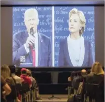  ?? THE ASSOCIATED PRESS ?? Republican presidenti­al nominee Donald Trump, left, and Democratic presidenti­al nominee Hillary Clinton are displayed on a big screen as viewers watch the second presidenti­al debate during a watch party at the University of Cincinnati on Sunday.