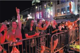  ??  ?? Fans line a section of Nashville’s Lower Broadway during the 57th anniversar­y party for Tootsie’s Orchid Lounge.