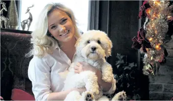  ?? ALISON LANGLEY/ NIAGARA FALLS REVIEW ?? Ally Nieuwestee­g, pictured with her dog Charlie, is the driving force behind the 12 Hours of Christmas event to be held at the Firemen's Park hall Friday from noon until midnight.